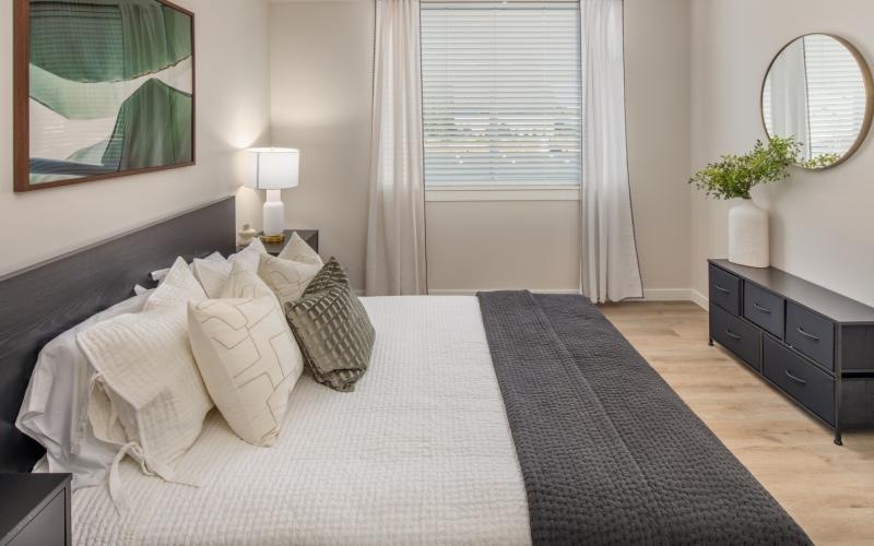 a bedroom with a bed and a dresser